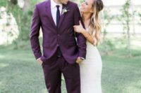 a purple groom suit with a thin black tie and black shoes is a gerat alternative to traditional black or grey