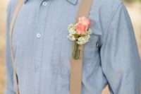 a rustic groom’s outfit with tan pants, tan suspenders, a chambray shirt and a floral boutonniere