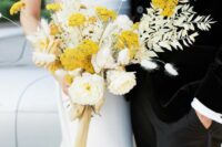 a stylish wedding bouquet of neutral peony roses, mimosas, white dried leaves and grasses is a statement idea for the fall