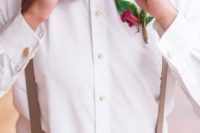 a summer groom’s look with a white shirt, creamy pants, beige suspenders, a burgundy bow tie and a bright floral boutonniere