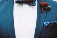 an elegant groom’s outfit with a white shirt, a navy blazer, a dark checked bow tie and a printed handkerchief is chic