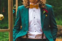 an emerald groom’s suit with a mustard bow tie and a white shirt plus copper waves and a full beard for a bold look