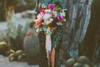 an emerald sequin maxi gown with long sleeves and a front slit is a bold choice for a modern bride