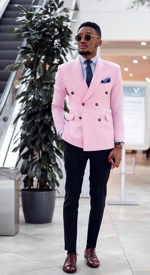 an eye catchy outfit with a blue shirt, a navy printed tie, a bright pink blazer, black pants and brown shoes is a gorgeous idea for a bright wedding