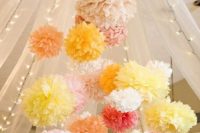 make a chandelier of pastel paper pompoms to add a fun touch to your wedding venue decor