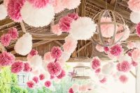 pink, white and blush paper pompoms hanging over the reception space look fun and bright