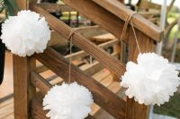 white paper pompoms accenting the stairs to make it look fresh and bright