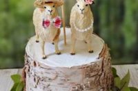 a birch bark wedding cake topped with two funny alpacas and a plywood heart is a lovely idea for a quirky wedding
