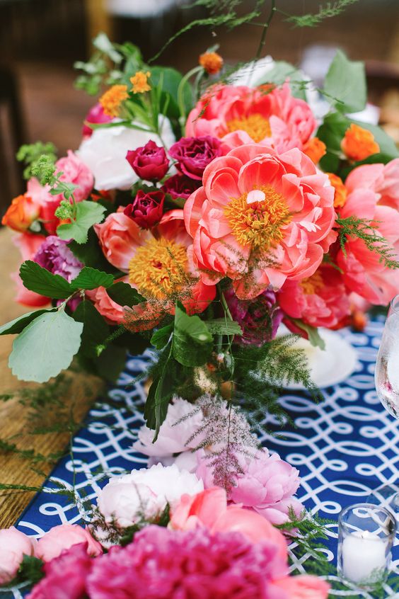 a bold spring wedding centerpiece in pink, fuchsia and white plus some foliage is super bright