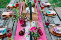 a bright hot pink and white dip dyed table runner lus matching bright florals for a boho tablescape