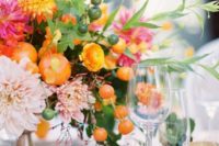 a bright spring wedding centerpiece in hot pink, marigold, blush and some citrus for a bold look