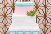 a bright square wedding cake with pink and green tiers with geometric patterns, a succulent and a chic topper