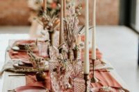 a bright terracotta wedding table runner and matching plates make the tablescape very bold and cool