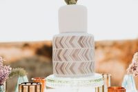 a chic desert wedding cake with a white and grey chevron tier, with a real cactus on top is a lovely idea for a mid-century modern or boho wedding
