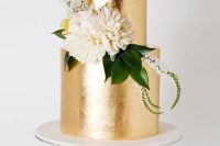 a chic gold leaf wedding cake with greenery and neutral blooms looks elegant and very bold