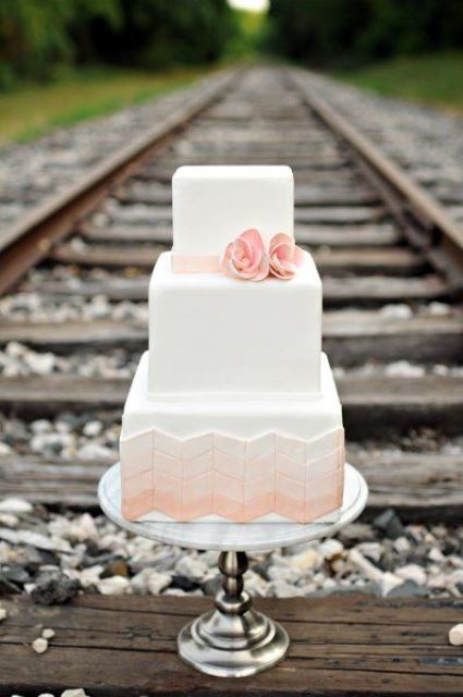 a delicate square wedding cake with white and ombre pink chevron tiers, with pink sugar blooms is a lovely idea for a spring or summer wedding