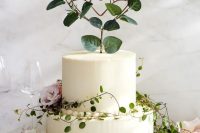 a garden wedding cake with greenery and blush blooms, a wire and leaf heart cake topper is a very beautiful and delicate idea to rock