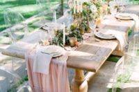 a spring wedding tablescape with a cool fabric table runner