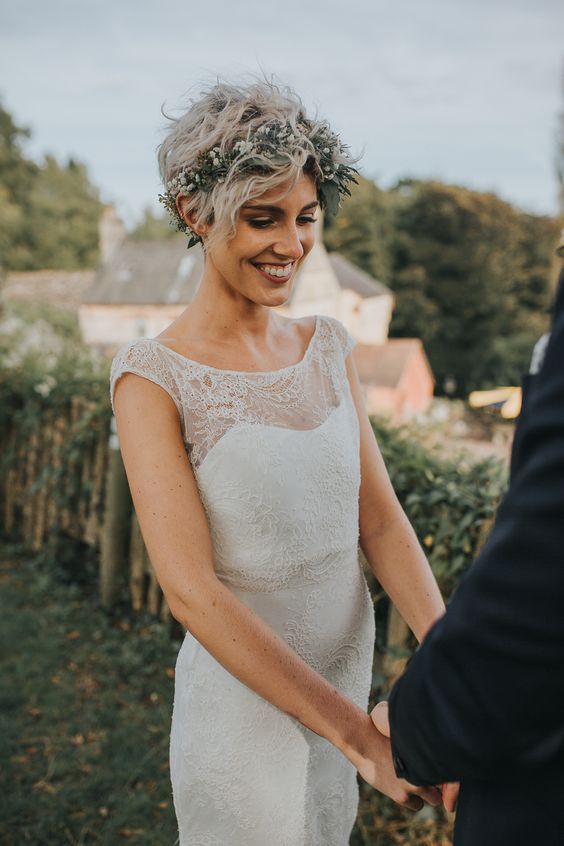 a long and wavy pixie haircut with a greenery and white floral crown is a lovely idea for a boho bride
