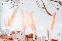 a mauve wedding table runner and terracotta napkins, pampas grass for a fall-colored wedding table setting