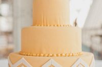a peachy round wedding cake with a chevron tier and sugar beads is a bold idea for a spring or summer wedding