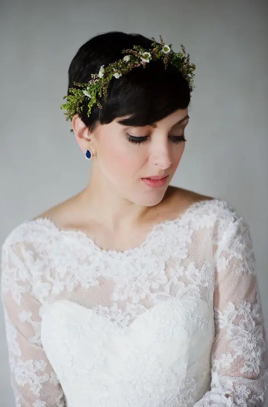 a pixie hairstyle with a fresh floral and greenery headband plus sapphire earrings for a statement