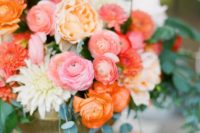 a romantic bright spring wedding centerpiece in pink, orange, white, light pink and peachy shades