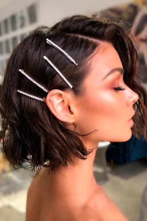 a short dark brown wavy bob with a texture and some pretty hairpins to fix one part is a very trendy idea