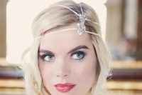 a short wavy hairstyle in the 1920s style with a rhinestone headpiece and a red lip for a flawless look
