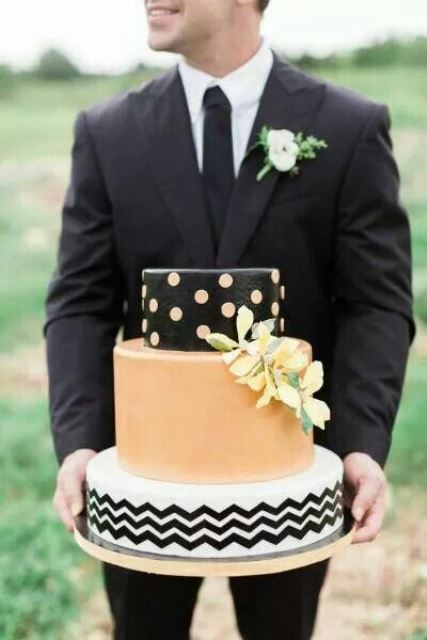 a stylish wedding cake with a peachy and black tier, a peachy tier and a black and white chevron tier plus yellow blooms is a lovely idea