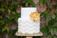a stylish wedding cake with light grey chevron decor, a yellow sugar flower is a lovely idea for a mid-century modern wedding