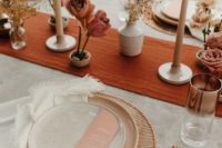 a terracotta fabric table runner paired with dried herbs and blooms, copper touches and wooden cutlery