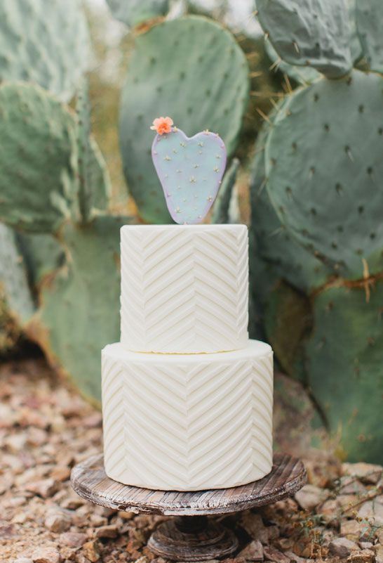 a white chevron wedding cake topped with a blooming cactus is a cool idea for a desert wedding, with a boho or mid-century modern feel