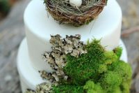 a white woodland wedding cake with moss and bark, with a faux nest and fake eggs is a lovely idea for a woodland wedding