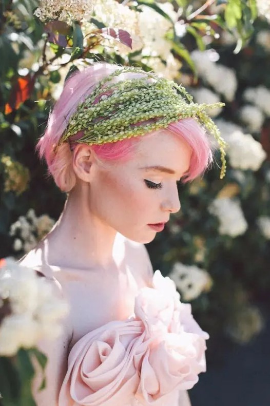 bright pink hair with greenery plus a blush wedding dress is a refined idea for a non-typical bridal look