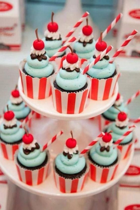 chocolate cupcakes with mint icing and little cherries in striped cupcake liners