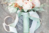 coral and white blooms, greenery in a mint wrap for a cool and bold wedding bouquet