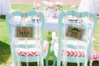 mint chairs with coral and white chevron seats, pompoms and signs for the couple