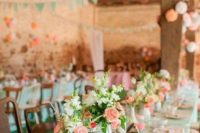 mint tablecloths, pink vases, coral and white blooms and greenery, paper pompoms and garlands
