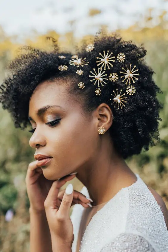 short naturally curly hair with beautiful gold and pearl hair pins and matching earrings for a chic look