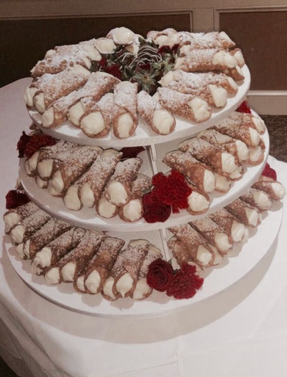 a cannoli tower is a popular idea for weddings, decorate it with fresh blooms and fresh berries