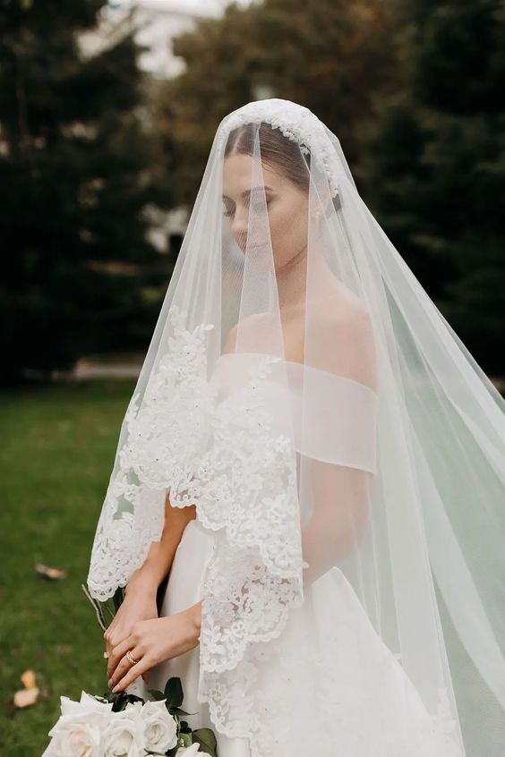 a cathedral veil with a lace trim is a gorgeous wedding accessory that will make a statement in your outfit