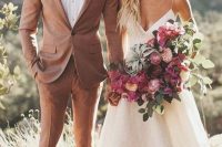 a dusty pink suit, a white shirt, a plaid bow tie and two tone shoes for a summer groom