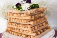 a fun and cozy churros wedding cake topped with fresh blooms is a tasty idea, add some dips around