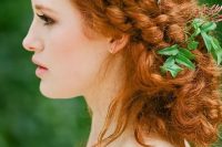 a gorgeous boho messy braided low updo with some fresh greenery tucked in is a great idea for a boho bride