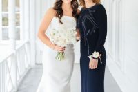 a gorgeous navy fitting maxi dress with embellishments, a high neckline and long sleeves is pure elegance and chic