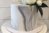 a grey marble mini cake with gold leaf and fresh white blooms and leaves is an elegant and chic idea
