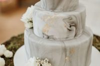 a grey marble wedding cake with gold leaf and white blooms is pure and timeless elegance