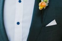 a grey suit, a white shirt with blue buttons, a plaid bow tie and a yellow bloom boutonniere for summer