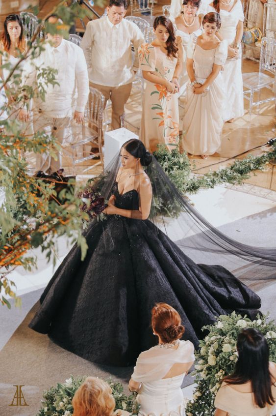 a jaw-dropping black wedding ballgown with a strapless embellished bodice, a full skirt with a train and a black veil